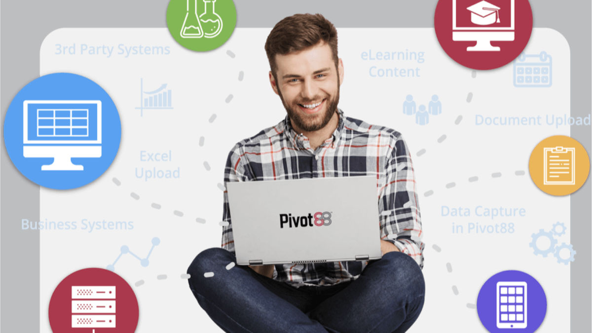 Happy young man sits with laptop showing how pivot88 integrates and consolidates data from various sources